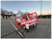 a white truck with a sold sign on it
