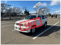 a white truck with a sold sign on it