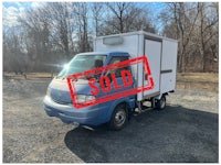 a white truck with a sold sign on it